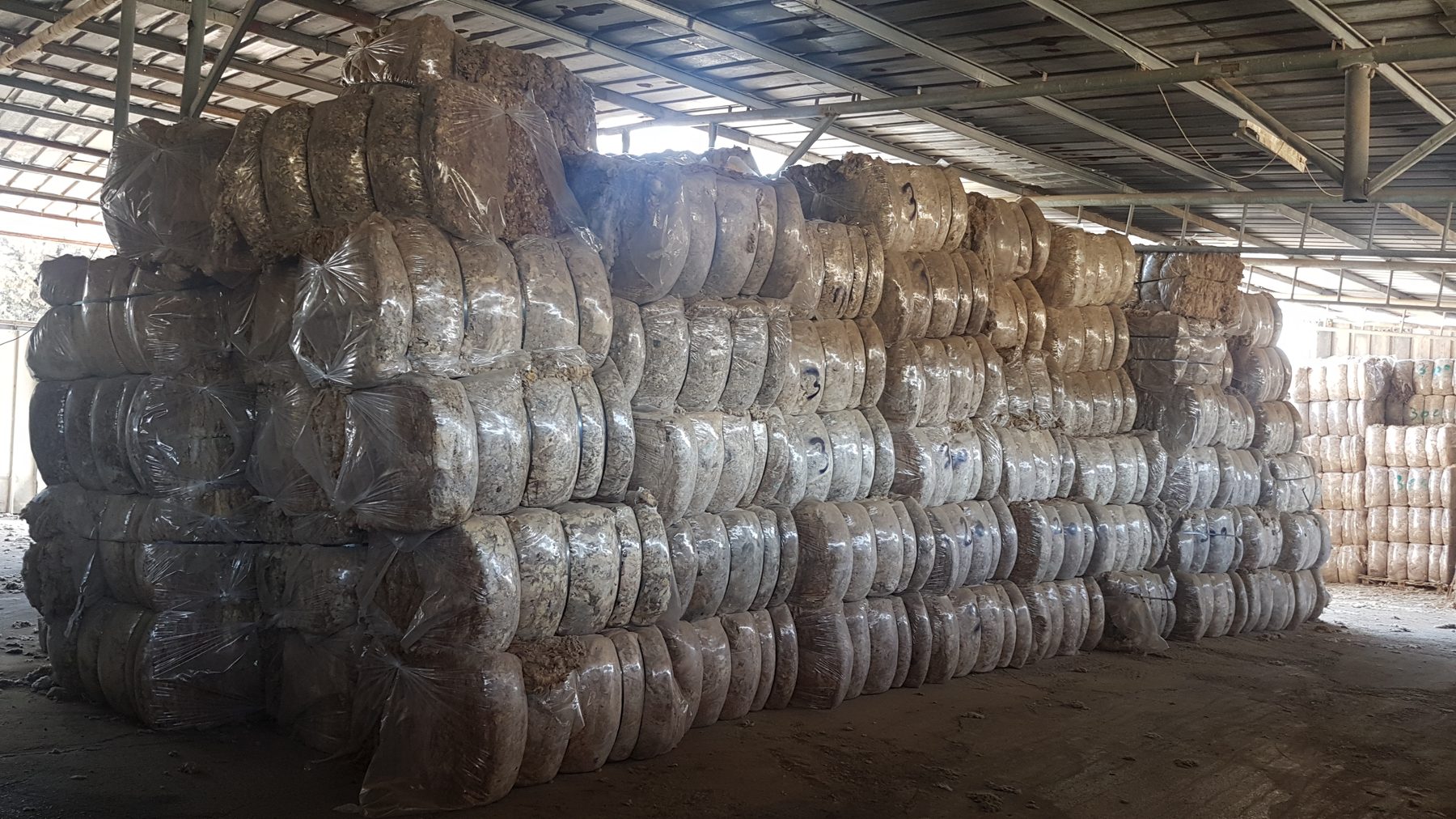 Wool bales stacked inside a KBD Fibers storage warehouse
